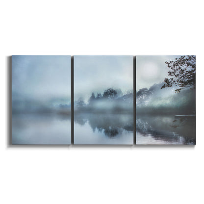 Three-panel canvas wall art featuring calm waters at sunrise photograph on white background.