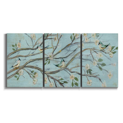 Three-panel canvas wall art featuring blue sky with flowering branches on white background.