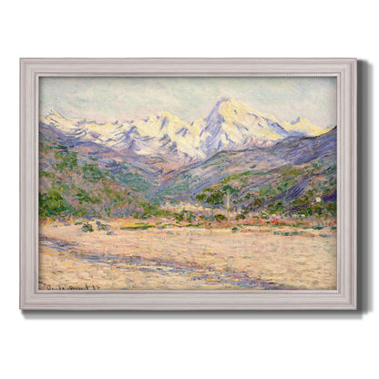 Impressionist valley landscape in southern France by Claude Monet printed on canvas in an ornate weathered white frame.