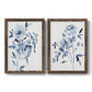 Set of two walnut barnwood framed canvas prints featuring two expressive watercolor botanical paintings featuring loose blue flowers and leafy branches.