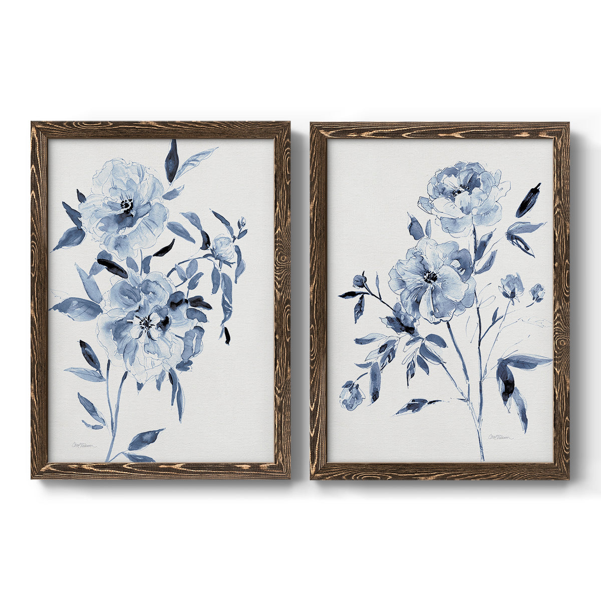 Set of two walnut barnwood framed canvas prints featuring two expressive watercolor botanical paintings featuring loose blue flowers and leafy branches.