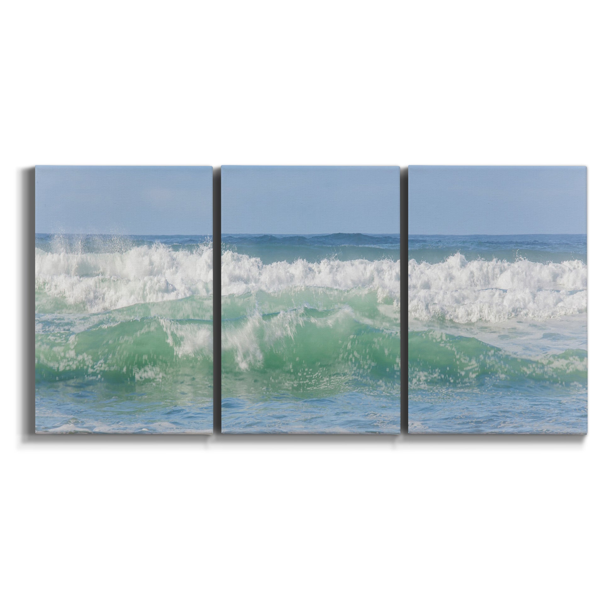 Three-panel canvas wall art featuring coastal waves breaking ashore on white background.