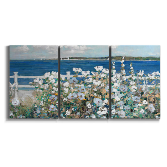 Three-panel canvas wall art featuring coastal garden overlooking bay on white background.