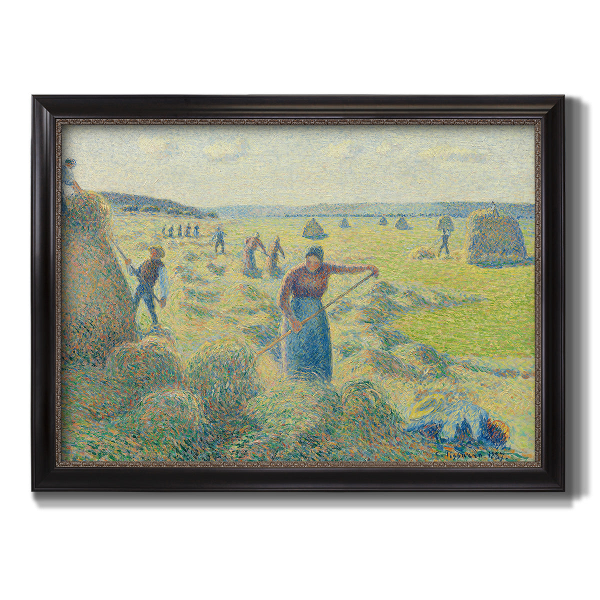 Impressionist rural hay harvest landscape by Camille Pissarro printed on canvas in an ornate black frame with gilded inner detail.