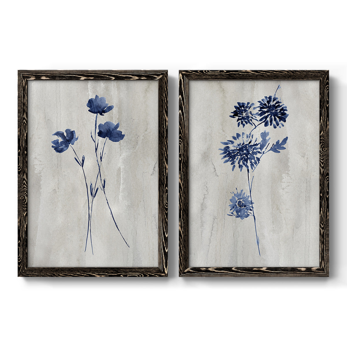 Set of two black barnwood framed canvas prints featuring two rustic monochrome botanical paintings featuring blue wildflower stems on weathered neutral paper.