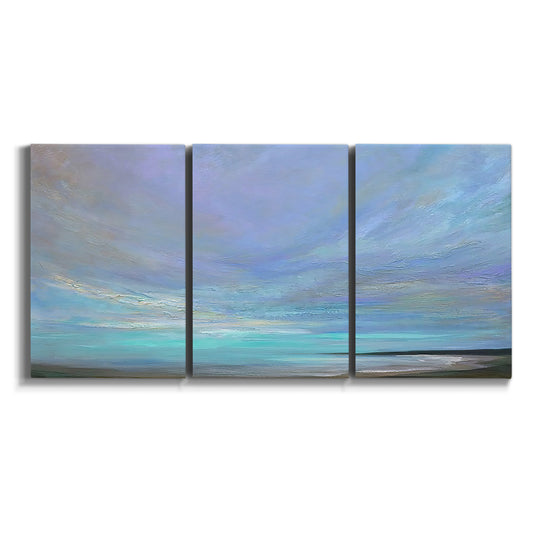 Three-panel canvas wall art featuring coastal shoreline with gentle surf on white background.