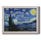 Iconic night sky landscape painting by Vincent van Gogh printed on canvas in an ornate weathered white frame.