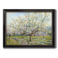 Impressionist white-blossomed orchard landscape by Vincent van Gogh printed on canvas in an ornate black frame with gilded inner detail.