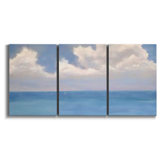Three-panel canvas wall art featuring coastal shoreline with distant horizon on white background.