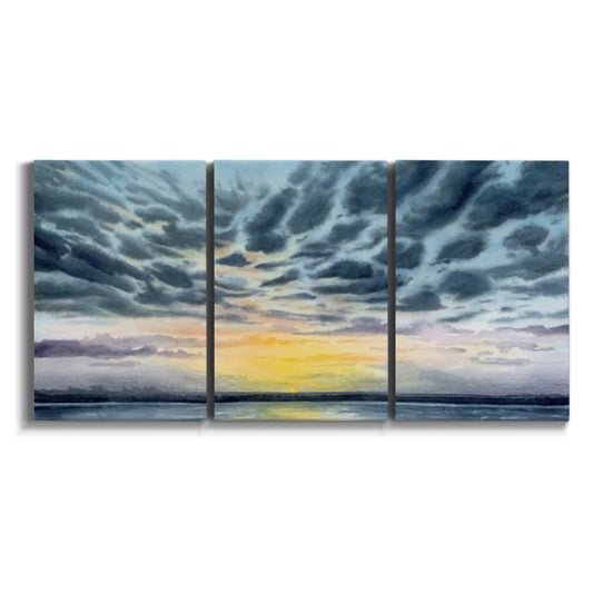 Three-panel canvas wall art featuring tropical coastal sunset over water on white background.