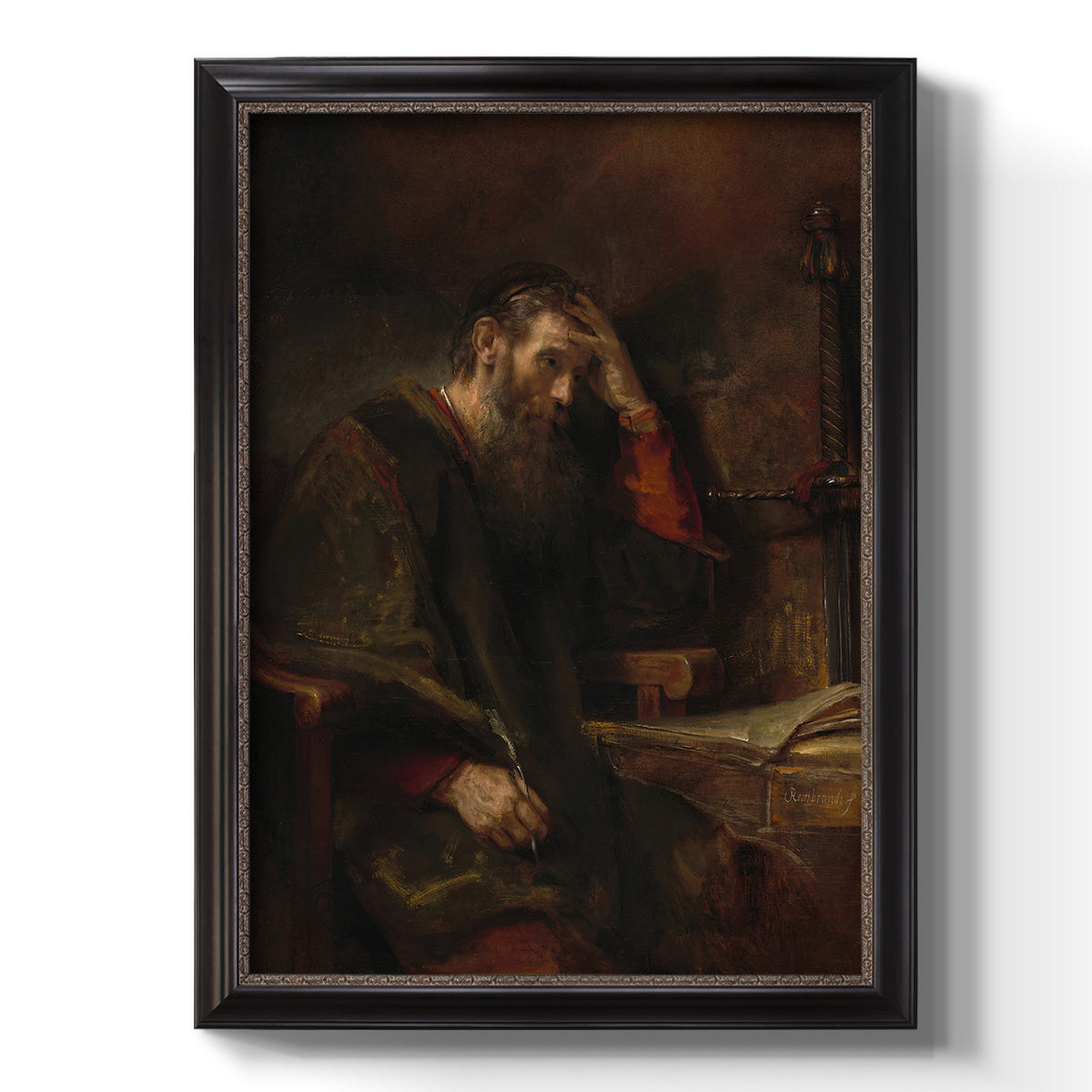 Classical religious portrait of Paul the Apostle by Rembrandt van Rijn printed on canvas in an ornate black frame with gilded inner detail with a vertical orientation.
