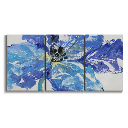 Three-panel canvas wall art featuring blue floral botanical close up on white background.