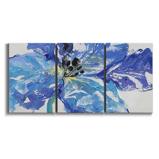 Three-panel canvas wall art featuring blue floral botanical close up on white background.
