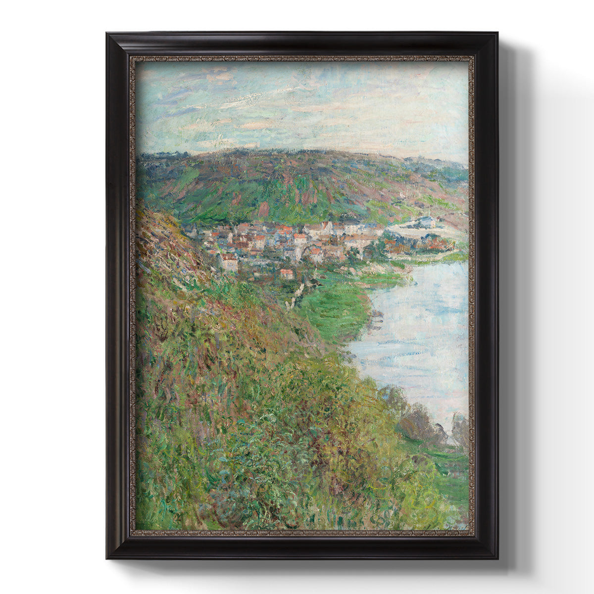 Impressionist landscape view of Vétheuil by Claude Monet printed on canvas in an ornate black frame with gilded inner detail with a vertical orientation.