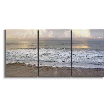 Three-panel canvas wall art featuring calm coastal shoreline seascape on white background.