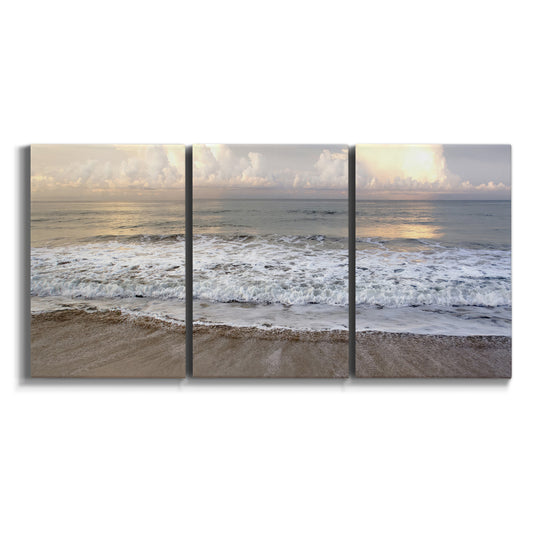 Three-panel canvas wall art featuring calm coastal shoreline seascape on white background.