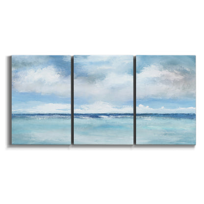 Three-panel canvas wall art featuring tropical clouds over ocean horizon on white background.