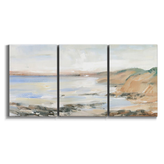 Three-panel canvas wall art featuring coastal shoreline landscape study on white background.