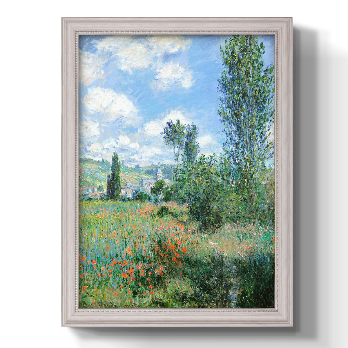 Impressionist pastoral landscape with poppy fields by Claude Monet printed on canvas in an ornate weathered white frame with a vertical orientation.