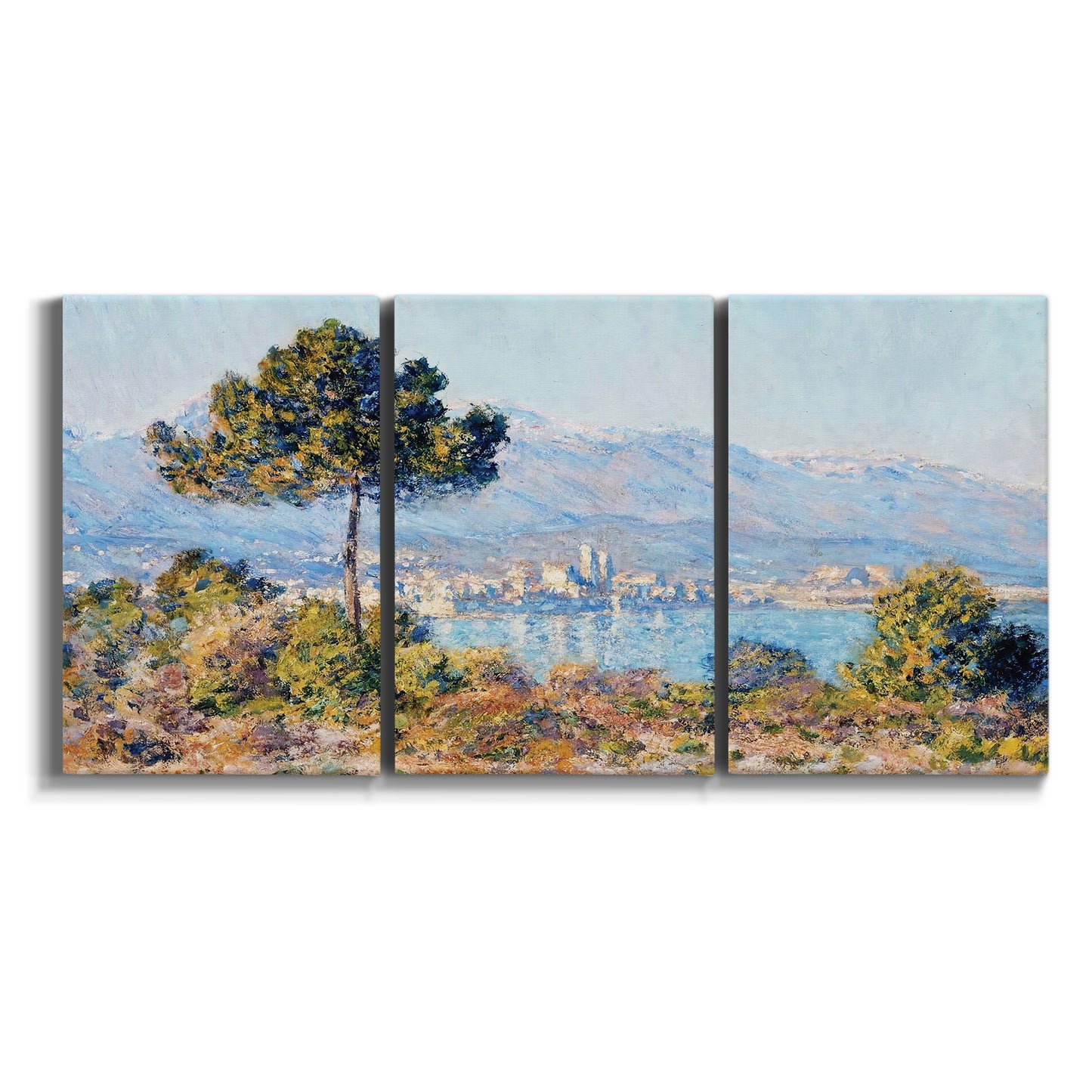 Three-panel canvas wall art featuring coastal town viewed from hillside on white background.