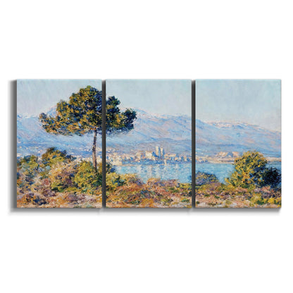 Three-panel canvas wall art featuring coastal town viewed from hillside on white background.
