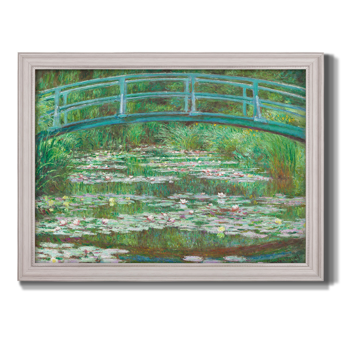 Impressionist garden scene with Japanese bridge and water lilies by Claude Monet printed on canvas in an ornate weathered white frame.