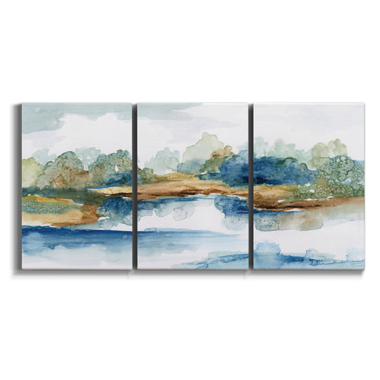 Three-panel canvas wall art featuring abstract blue watercolor landscape on white background.