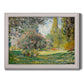 Impressionist park landscape in Paris by Claude Monet printed on canvas in an ornate weathered white frame.