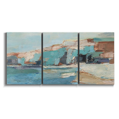 Three-panel canvas wall art featuring coastal shoreline with soft waves on white background.