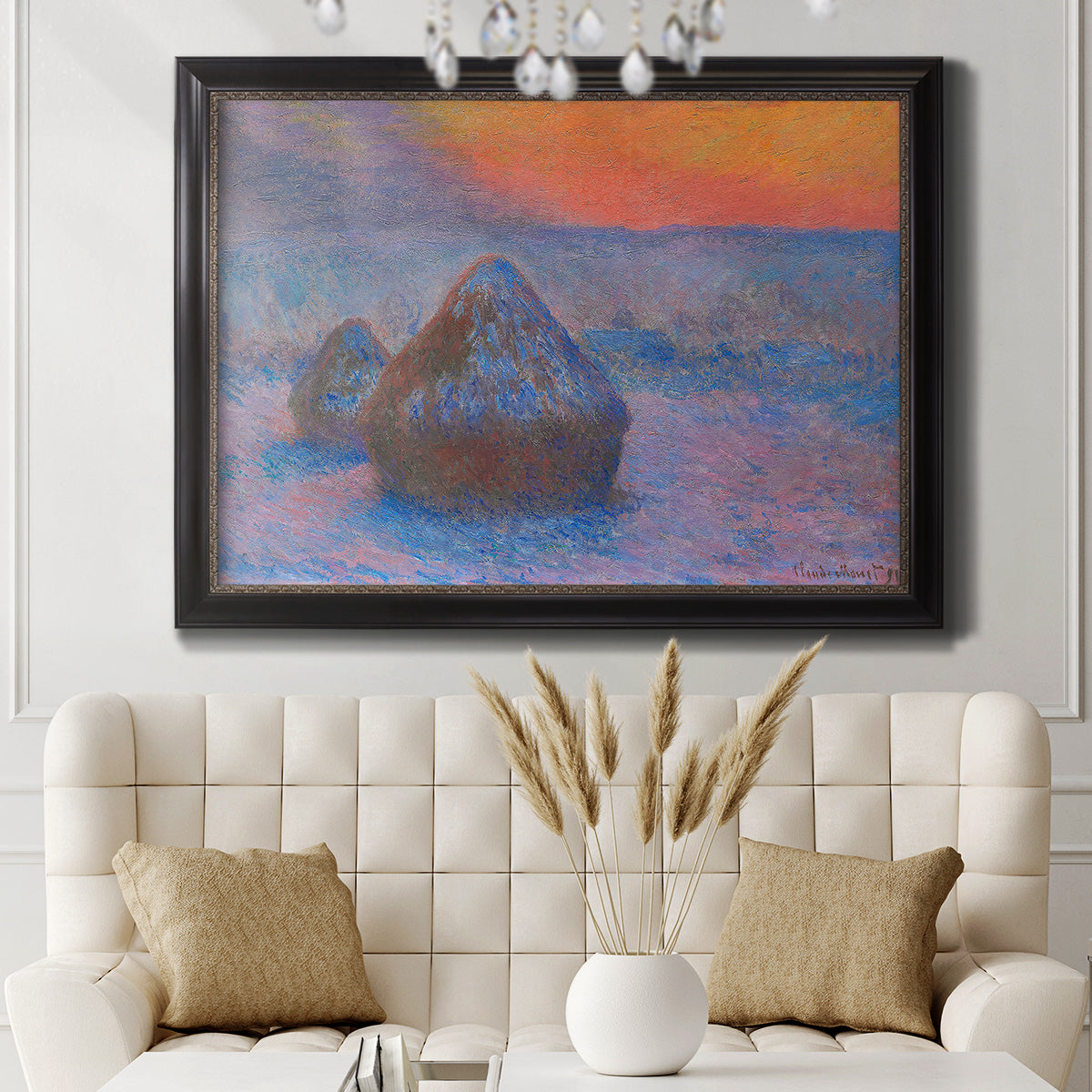 Impressionist haystack scene at sunset by Claude Monet in an ornate black frame with gilded inner detail displayed in a neutral-toned interior setting.