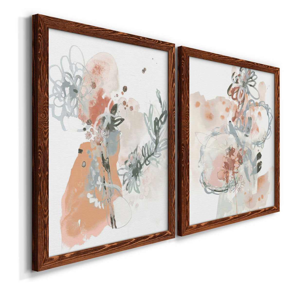 Angled view of a set of two maple barnwood framed canvas prints featuring two abstract watercolor botanicals featuring loose blush gray and coral floral gestures.