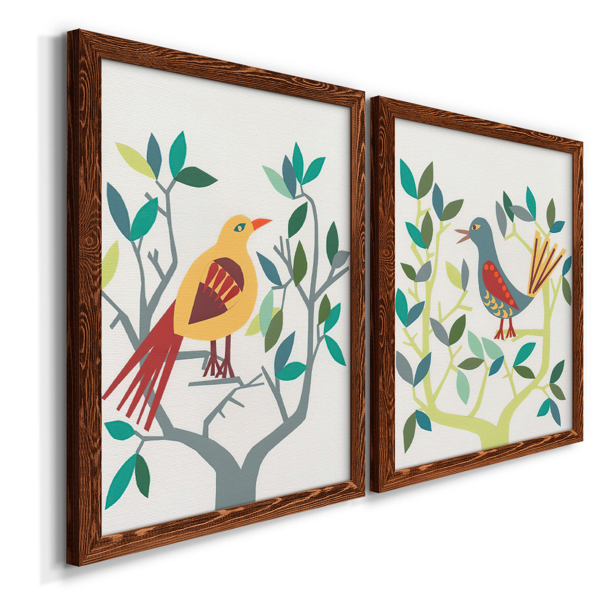Angled view of a set of two maple barnwood framed canvas prints featuring two modern folk-art bird illustrations featuring stylized colorful birds perched among leafy branches.