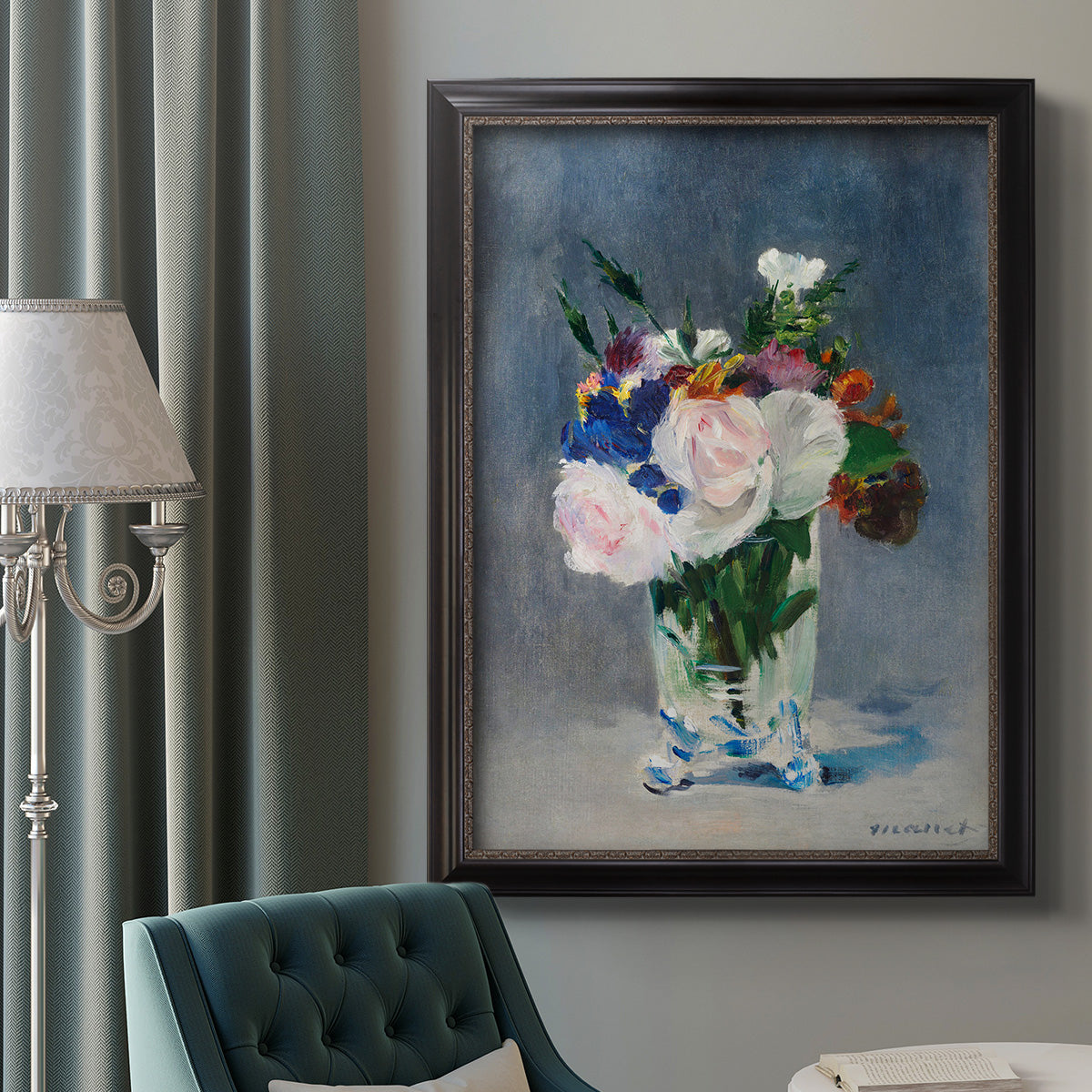 Impressionist floral still life painting by Claude Monet in an ornate black frame with gilded inner detail displayed in a neutral interior setting.