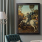 Religious painting of Saint George slaying the dragon by Raphael in an ornate black frame with gilded inner detail displayed in a neutral interior setting.