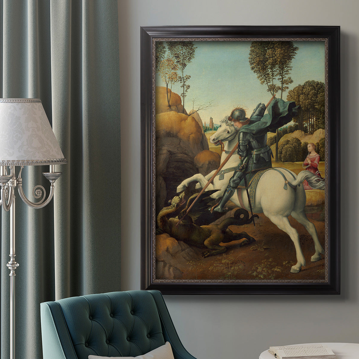 Religious painting of Saint George slaying the dragon by Raphael in an ornate black frame with gilded inner detail displayed in a neutral interior setting.