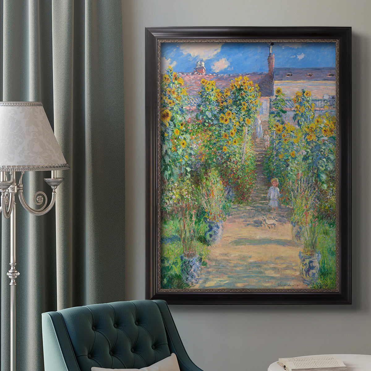 Impressionist garden landscape painting by Claude Monet in an ornate black frame with gilded inner detail displayed in a neutral interior setting.