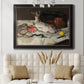 Impressionist still life painting of fish by Édouard Manet in an ornate black frame with gilded inner detail displayed in a neutral-toned interior setting.