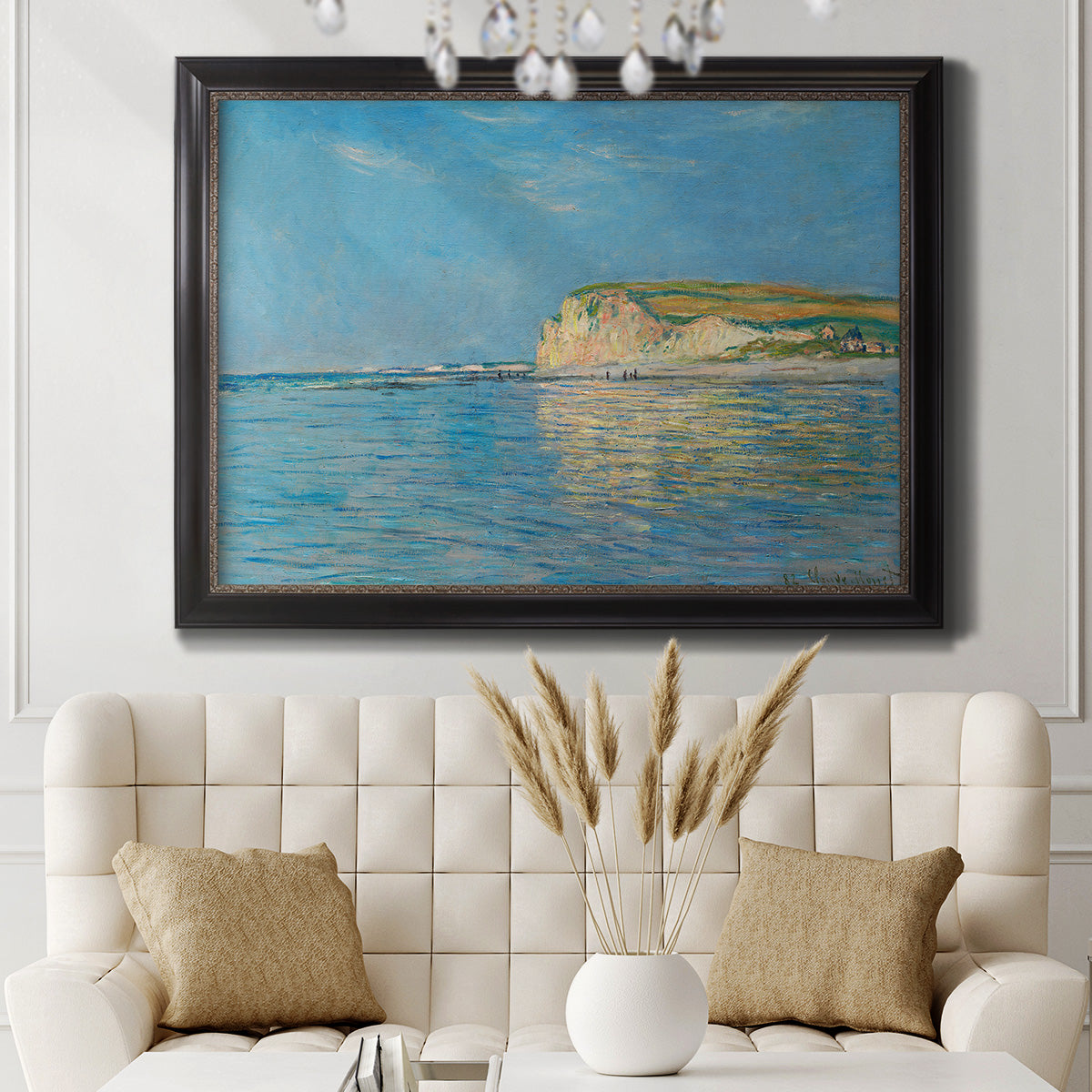 Impressionist coastal low-tide seascape at Pourville by Claude Monet in an ornate black frame with gilded inner detail displayed in a neutral-toned interior setting.