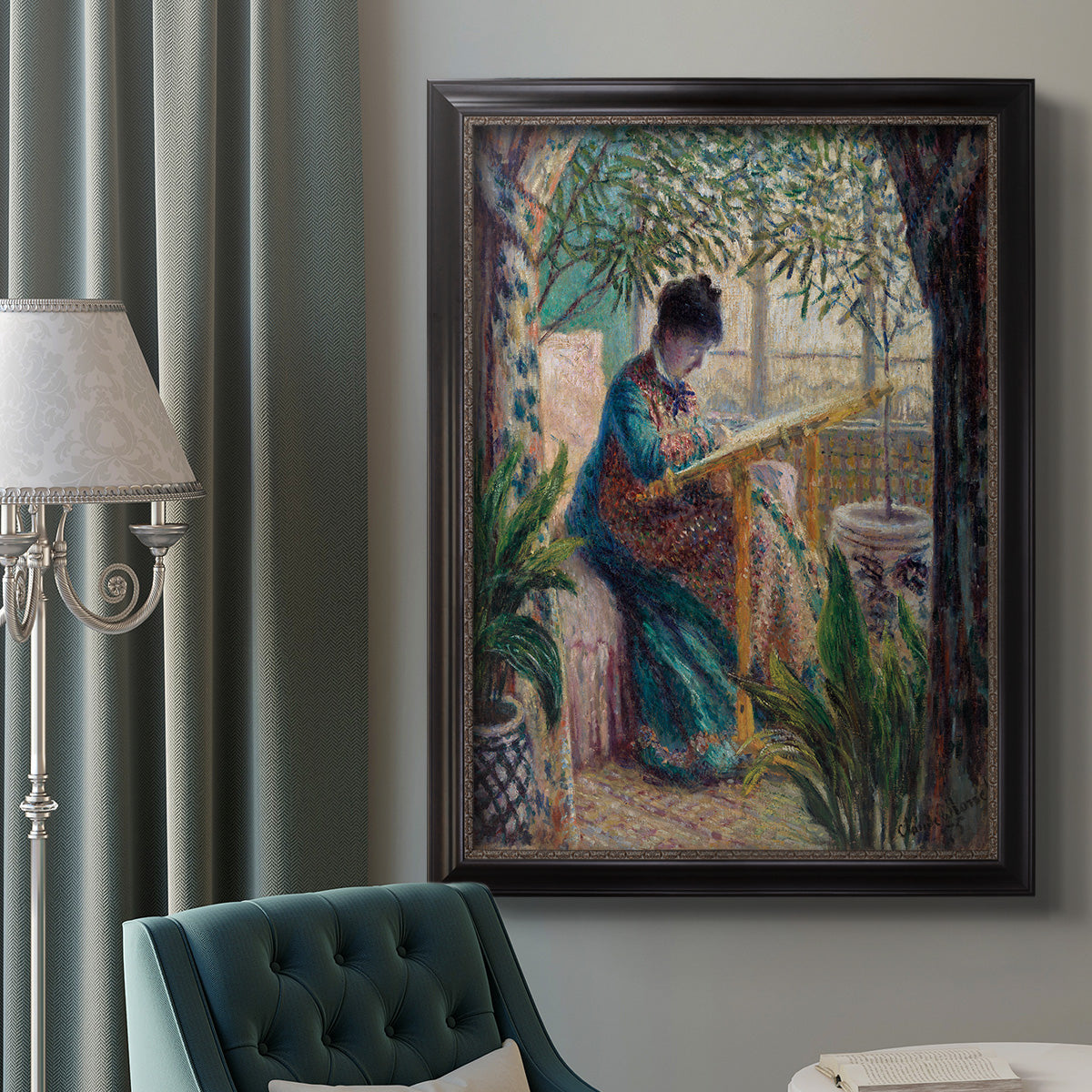 Impressionist portrait of Madame Monet sewing by Claude Monet in an ornate black frame with gilded inner detail displayed in a neutral interior setting.