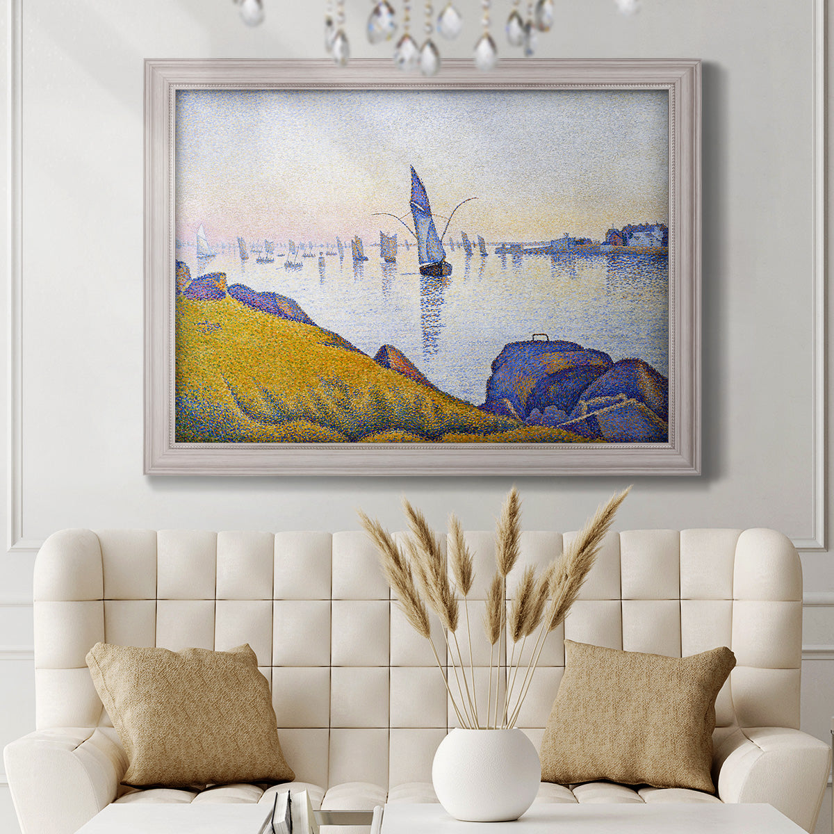 Impressionist coastal harbor at dusk by Paul Signac in an ornate weathered white frame displayed in a neutral-toned interior setting.