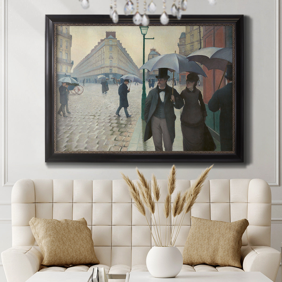 Impressionist urban street scene in the rain by Gustave Caillebotte in an ornate black frame with gilded inner detail displayed in a neutral-toned interior setting.