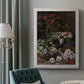 Early impressionist floral painting by Claude Monet in an ornate weathered white frame displayed in a neutral interior setting.