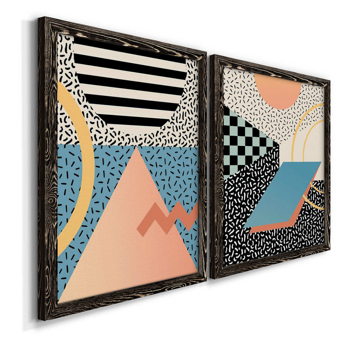 Angled view of a set of two black barnwood framed canvas prints featuring two retro graphic abstracts featuring bold geometric Memphis-style patterns.