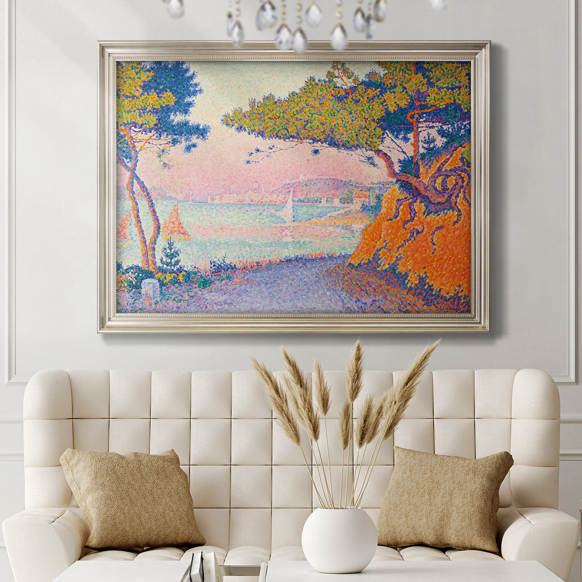 Pointillist coastal seascape by Paul Signac in an ornate champagne frame displayed in a neutral-toned interior setting.