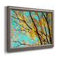 Bright autumn leaves against a blue sky printed on canvas in an ornate vintage silver frame.
