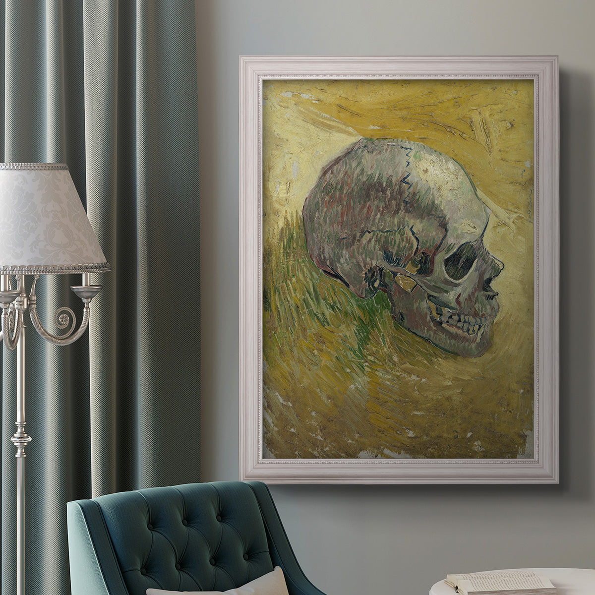 Profile skull study artwork by Vincent van Gogh in an ornate weathered white frame displayed in a neutral interior setting.