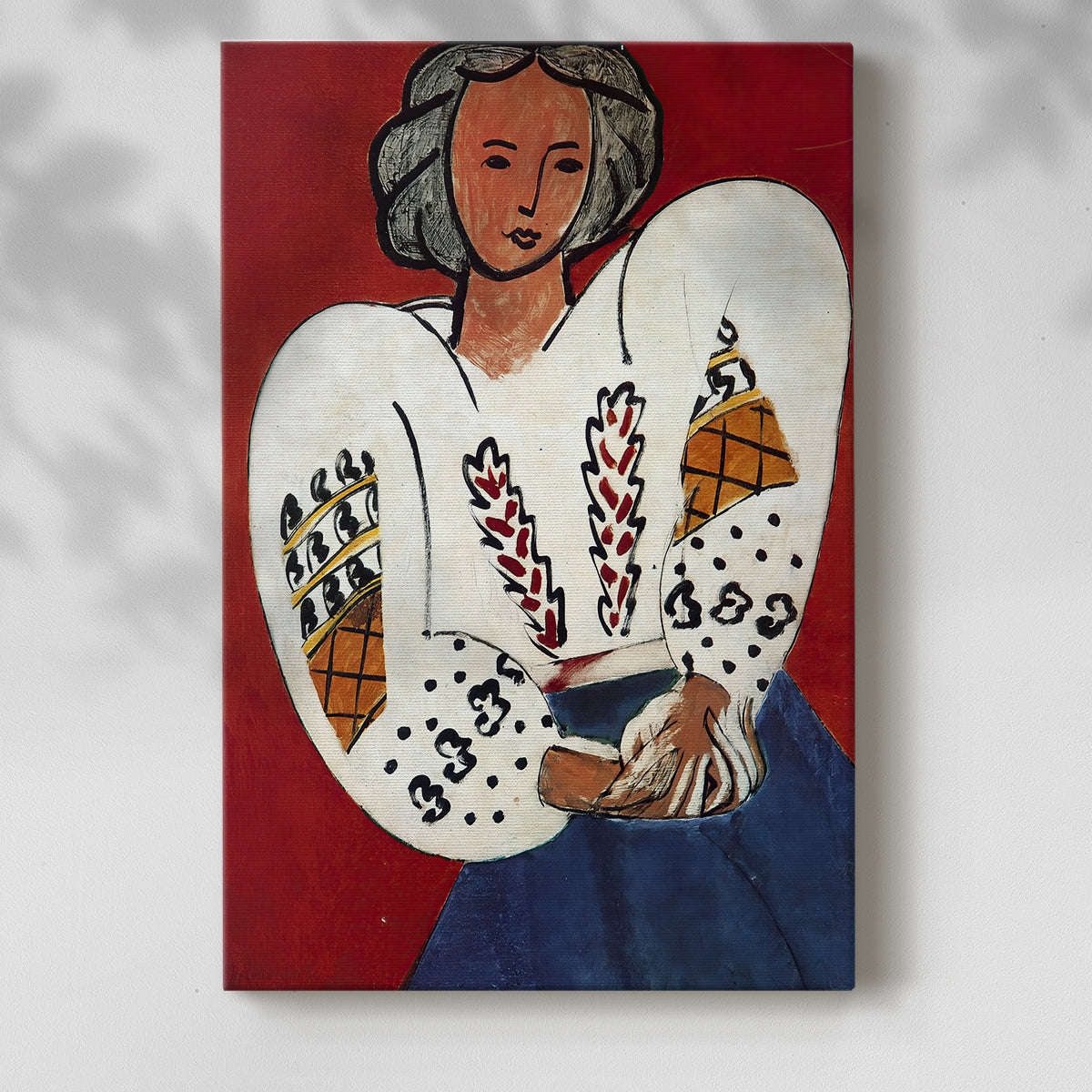 Canvas art print of a stylized figure with intricate textile design and vivid tones with a soft shadow on a white background.