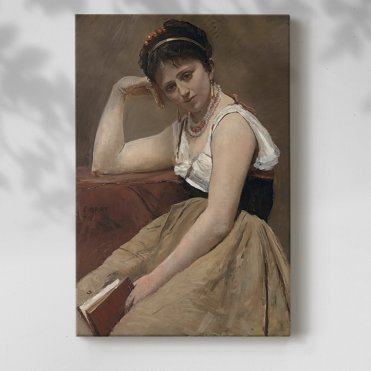 Canvas art print of a quiet interior moment with a seated figure and book with a soft shadow on a white background.