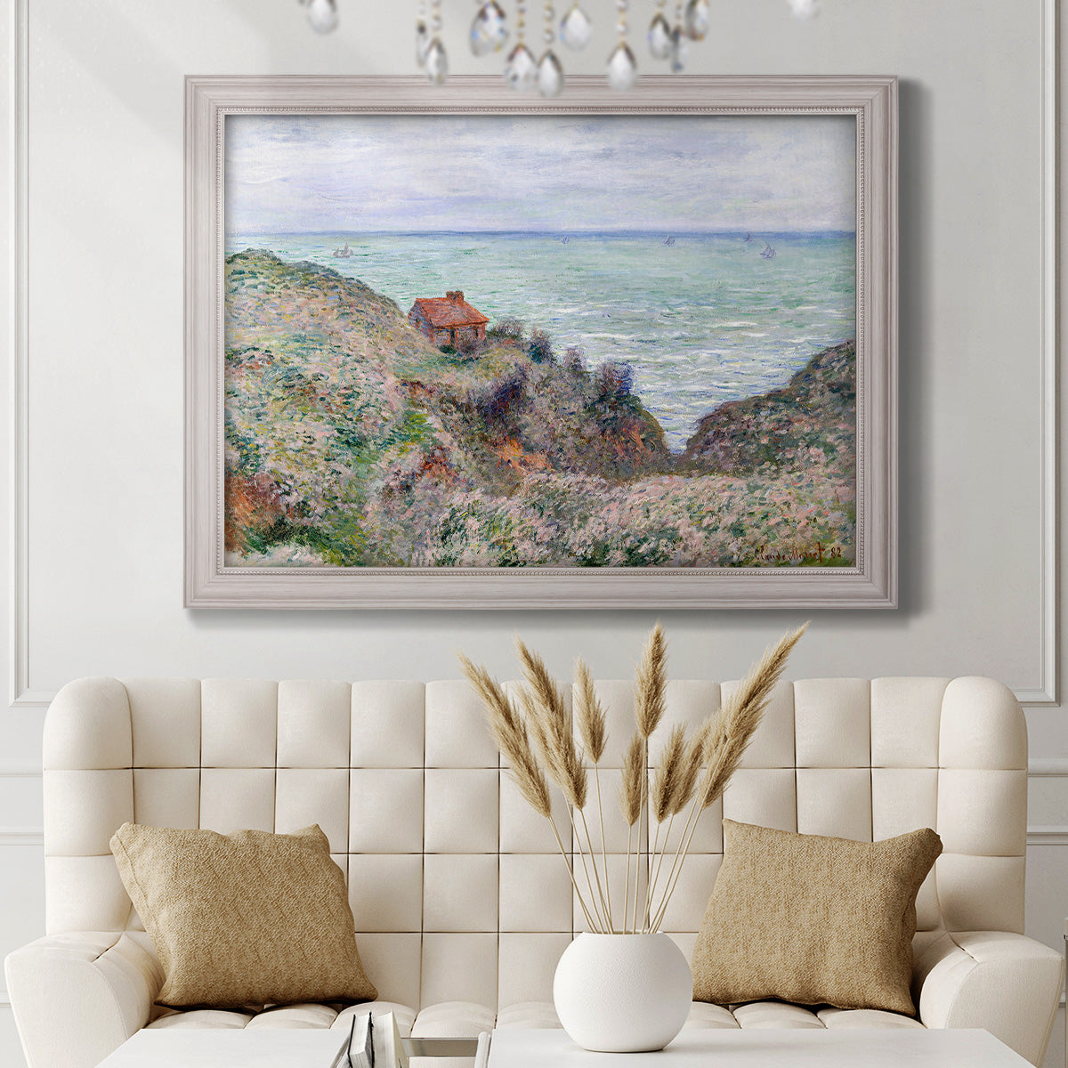 Impressionist coastal watch cabin scene by Claude Monet in an ornate weathered white frame displayed in a neutral-toned interior setting.