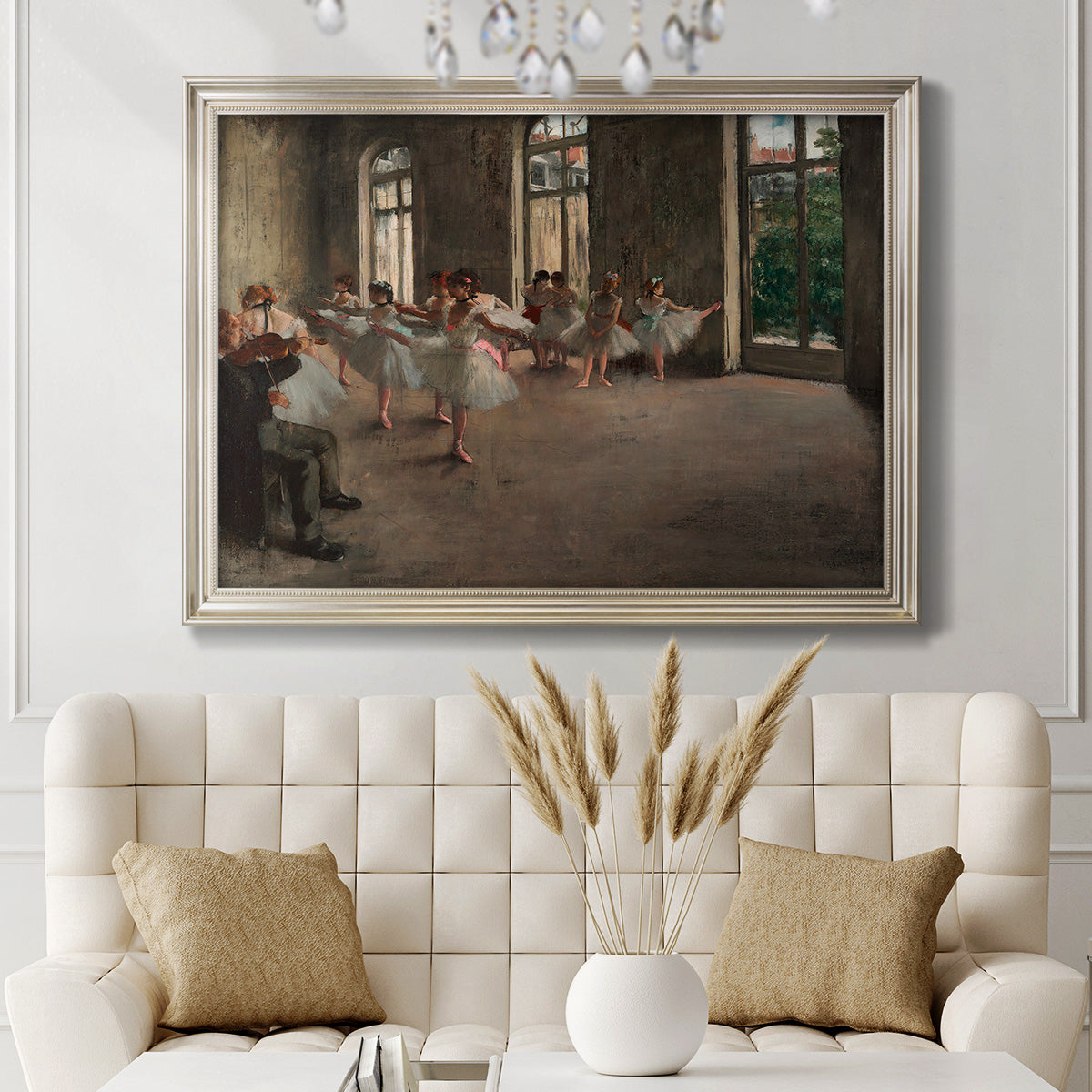 Early impressionist ballet rehearsal painting by Edgar Degas in an ornate champagne frame displayed in a neutral-toned interior setting.
